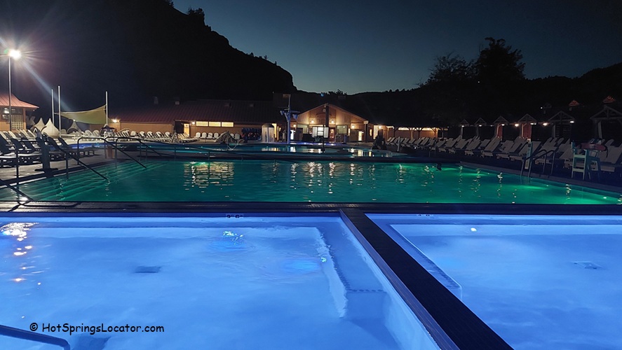 Kah-Nee-Ta Resort and Spa in Idaho: The picture "Kah-Nee-Ta Resort and Spa in Oregon illuminated pools at night" captures the resort’s swimming pools glowing with blue and green lights after dark, with rows of lounge chairs and the main lodge visible in the distance.